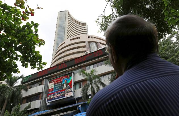 A man looks at a screen across a road displaying the Sensex on the facade of the Bombay Stock Exchange building in Mumbai. (REUTERS) A man looks at a screen across a road displaying the Sensex on the facade of the Bombay Stock Exchange building in Mumbai. (REUTERS)