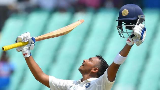 India's Prithvi Shaw celebrates after scoring a century (100 runs) during the first of the first Test cricket match between India and West Indies at the Saurashtra Cricket Association stadium in Rajkot. (AFP)