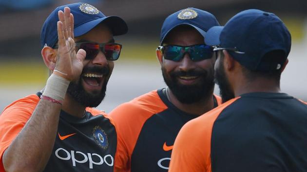 Indian cricket captain Virat Kohli (L) jokes with teammates Mohammed Shami (C) and Ravindra Jadeja (R). (AFP)