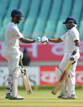India's batsmen Cheteshwar Pujara (L) and Prithvi Shaw touch fists during the first day's play of the first Test cricket match between India and West Indies at the Saurashtra Cricket Association stadium in Rajkot. (AFP) India's batsmen Cheteshwar Pujara (L) and Prithvi Shaw touch fists during the first day's play of the first Test cricket match between India and West Indies at the Saurashtra Cricket Association stadium in Rajkot. (AFP)