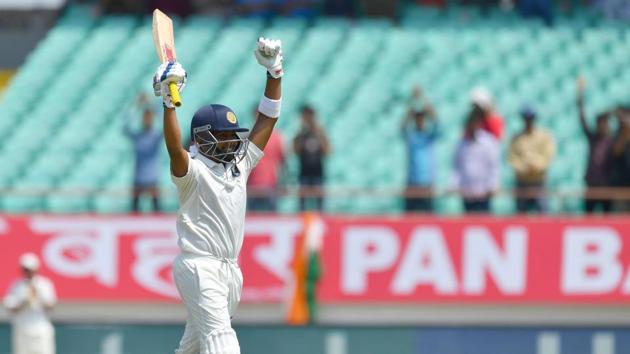 India's Prithvi Shaw celebrates after scoring a century (100 runs) during the first of the first Test cricket match between India and West Indies at the Saurashtra Cricket Association stadium in Rajkot.(AFP)