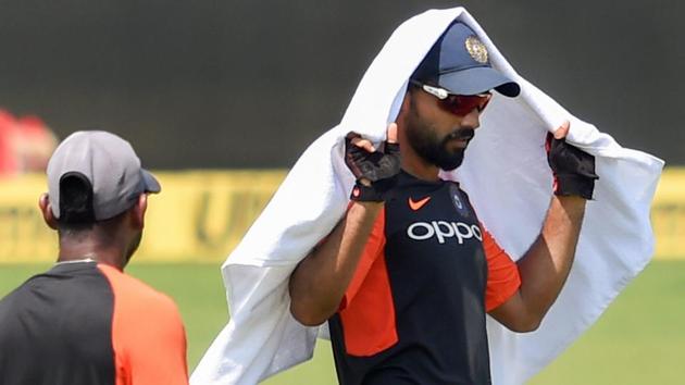 Ajinkya Rahane takes cover from the heat during a practice session ahead of their first test match against West Indies. (PTI)