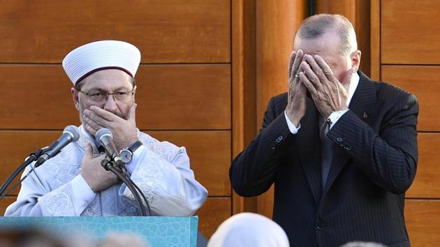 Turkish President Recep Tayyip Erdogan (R) and Diyanet President Ali Eras cover their faces during a prayer on occasion of the opening of the new mosque in Cologne, Germany. (Martin Meissner / AP) Turkish President Recep Tayyip Erdogan (R) and Diyanet President Ali Eras cover their faces during a prayer on occasion of the opening of the new mosque in Cologne, Germany. (Martin Meissner / AP)