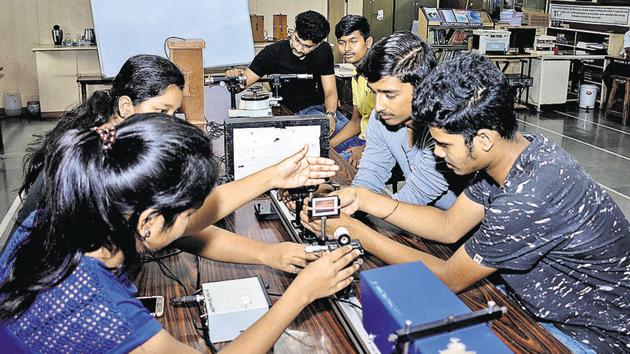 Students of MIT college perform an experiment on Laser in the Physics lab on Thursday. The book, Bharatiya Vidya Saar, claims that Rigveda accurately mentions the speed of light.(Milind Saurkar/HT Photo)