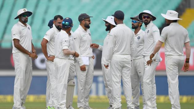 Teammates congratulate India's Mohammed Shami for taking the wicket of West indies' batsman Kraigg Brathwaite during the second day's play of the first Test cricket match between India and West Indies at the Saurashtra Cricket Association stadium in Rajkot. (AFP)