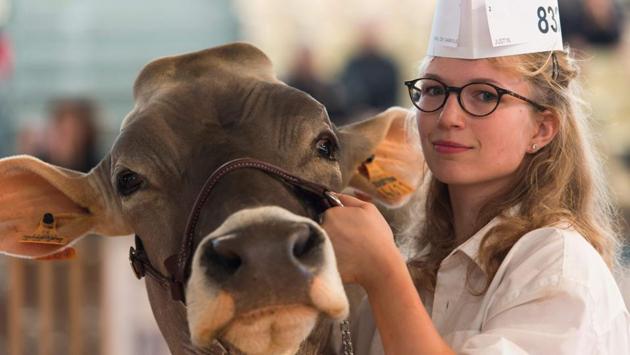 A milkmaid poses with a French breed Brune cow (French Brown), during the third day of the ‘Sommet de l’Élevage 2018’ Trade Fair in Cournon-d’Auvergne, near Clermont Ferrand in central France. (Thierry Zoccolan / AFP) A milkmaid poses with a French breed Brune cow (French Brown), during the third day of the ‘Sommet de l’Élevage 2018’ Trade Fair in Cournon-d’Auvergne, near Clermont Ferrand in central France. (Thierry Zoccolan / AFP)