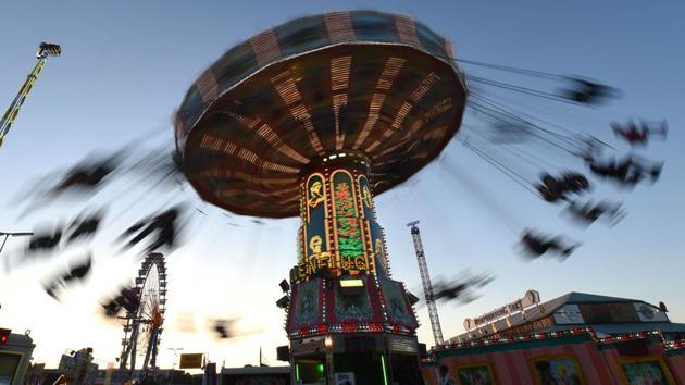 A long time exposure shows visitors sitting on a carousel at the Theresienwiese fairground of the Oktoberfest beer festival in Munich, southern Germany. (Christof Stache / AFP) A long time exposure shows visitors sitting on a carousel at the Theresienwiese fairground of the Oktoberfest beer festival in Munich, southern Germany. (Christof Stache / AFP)