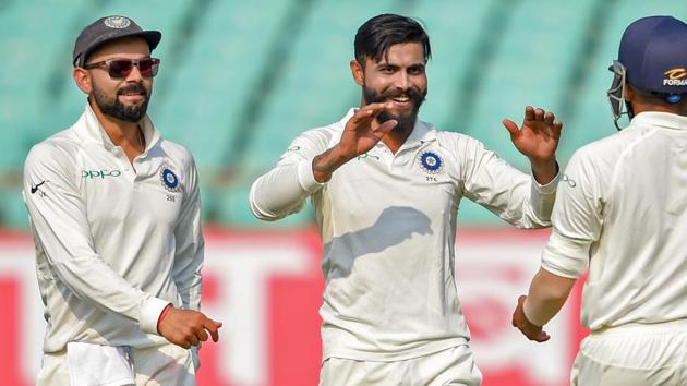 Rajkot: Indian bowler Ravindra Jadeja (C) celebrates the wicket of West Indies batsman Sunil Ambris as team captain Virat Kohli (L) looks on, during their first test cricket match, in Rajkot. (PTI) Rajkot: Indian bowler Ravindra Jadeja (C) celebrates the wicket of West Indies batsman Sunil Ambris as team captain Virat Kohli (L) looks on, during their first test cricket match, in Rajkot. (PTI)