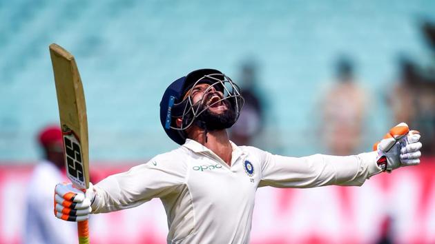 Indian Batsman Ravindra Jadeja celebrates his century during the first test cricket match played between India and West Indies in Rajkot. Jadeja struck an unbeaten 100 off 132 off balls as India extended their domination with the bat against West Indies. His whirlwind effort in front of home crowd came after skipper Virat Kohli (139 off 230) completed his 24th Test hundred in the morning. (Shashank Parade / PTI)