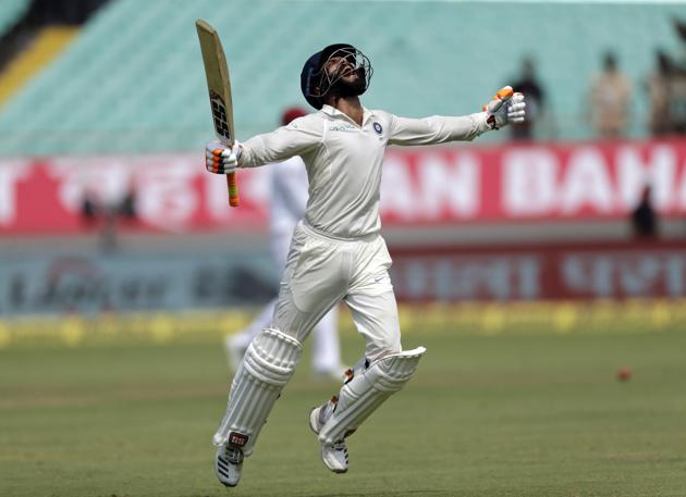 Indian cricketer Ravindra Jadeja celebrates his century during the second day of the first cricket test match between India and West Indies in Rajkot. (AP)