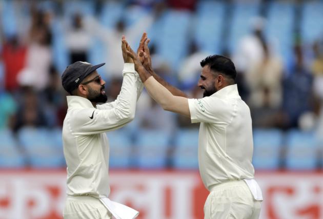 Indian cricketer Mohammed Shami, right, celebrates with teammate Virat Kohli after dismissing West Indies' Kieran Powell's during the second day of the first cricket test match between India and West Indies in Rajkot. (AP)
