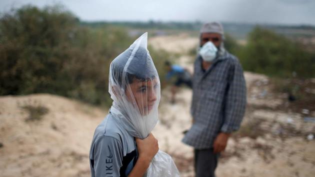 A Palestinian boy covers his face with a plastic bag to protect himself from tear gas fired by Israeli troops during a protest calling for lifting the Israeli blockade on Gaza, on a beach near the maritime border with Israel, in the northern Gaza Strip. (Mohammed Salem / REUTERS) A Palestinian boy covers his face with a plastic bag to protect himself from tear gas fired by Israeli troops during a protest calling for lifting the Israeli blockade on Gaza, on a beach near the maritime border with Israel, in the northern Gaza Strip. (Mohammed Salem / REUTERS)