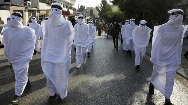 Palestinian members of the Al-Quds Brigades, the military wing of the Islamic Jihad group, wear clothes to represent shrouds while marching to show loyalty for the Iranian-backed Palestinian movement’s newly elected leader Ziad al-Nakhalah during a rally along the streets of Gaza. (Adel Hana / AP) Palestinian members of the Al-Quds Brigades, the military wing of the Islamic Jihad group, wear clothes to represent shrouds while marching to show loyalty for the Iranian-backed Palestinian movement’s newly elected leader Ziad al-Nakhalah during a rally along the streets of Gaza. (Adel Hana / AP)