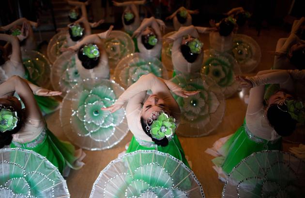 A group of square dancers practice during a city-wide dance competition. Local contests are proliferating. Shanghai retiree Li Zhenhua’s team worked with a professional instructor for weeks, enduring the winter chill and the summer heat of their local square to train for a months-long citywide contest that culminated in August. (Johannes Eisele / AFP) A group of square dancers practice during a city-wide dance competition. Local contests are proliferating. Shanghai retiree Li Zhenhua’s team worked with a professional instructor for weeks, enduring the winter chill and the summer heat of their local square to train for a months-long citywide contest that culminated in August. (Johannes Eisele / AFP)