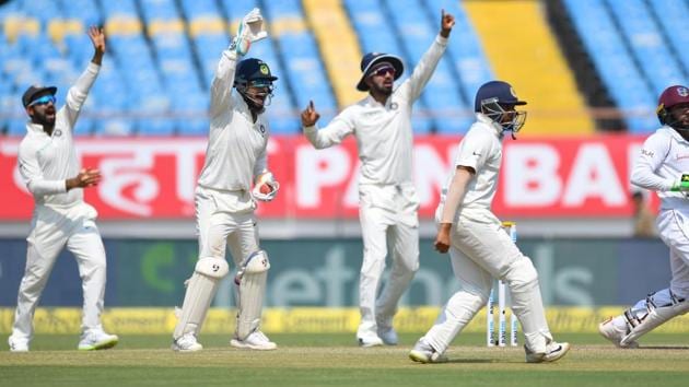(L-R) Indian cricketers Ajinkya Rahane, Richabh Pant, KL Rahul and Prithvi Shaw appeal successfully for a caught behind against West Indies Batsman Devendra Bishoo (R) during the third day's play of the first Test cricket match between India and West Indies at the Saurashtra Cricket Association Stadium in Rajkot (AFP)