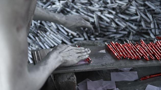 A worker prepares firecrackers at a workshop ahead of Diwali on the outskirts of Ahmedabad, Gujarat on October 4, 2018. (Sam Panthaky / AFP) A worker prepares firecrackers at a workshop ahead of Diwali on the outskirts of Ahmedabad, Gujarat on October 4, 2018. (Sam Panthaky / AFP)