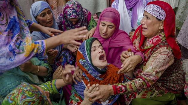 Ruksana Nazir (C), is comforted during the funeral of her husband Nazir Ahmed Wani in Srinagar, Kashmir on October 5, 2018. Suspected rebels shot and killed two activists, which included Wani. (Dar Yasin / AP) Ruksana Nazir (C), is comforted during the funeral of her husband Nazir Ahmed Wani in Srinagar, Kashmir on October 5, 2018. Suspected rebels shot and killed two activists, which included Wani. (Dar Yasin / AP)