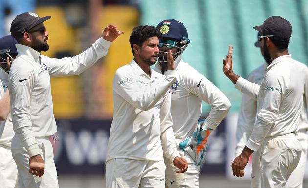 Rajkot: Indian bowler Kuldeep Yadav with his teammates celebrates the wicket of West Indies batsman Shai Hope during their first test cricket match, in Rajkot. (PTI)