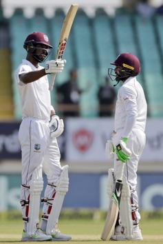 West Indies' cricketer Roston Chase celebrates his fifty during the third day of the first cricket test match between India and West Indies in Rajkot. (AP)