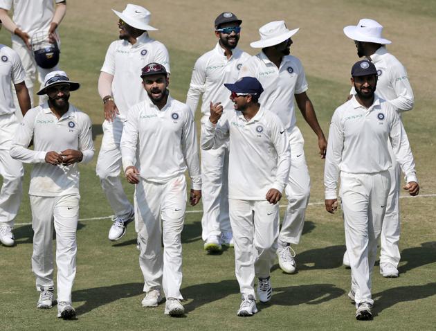 Indian cricketers celebrate after their victory over West Indies in the first cricket test match in Rajkot. (AP)