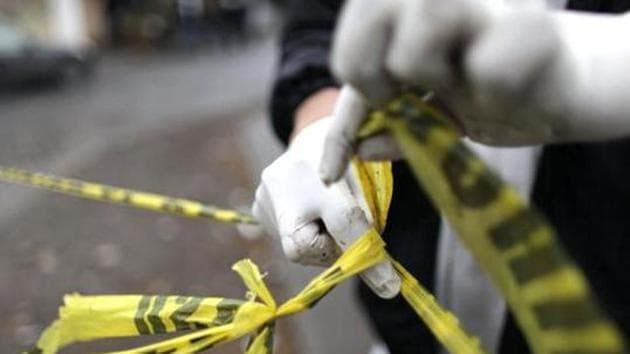 A forensic technician ties a used police line together to seal off a crime scene in Monterrey.(Reuters Photo/Representative Image) A forensic technician ties a used police line together to seal off a crime scene in Monterrey.(Reuters Photo/Representative Image)