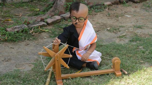 A boy dressed as Mahatma Gandhi sits with a wooden charkha or spinning wheel at the lawns of the Gujarat Vidhyapith to commemorate the 149th birth anniversary of Mahatma Gandhi, in Ahmedabad, on October 1, 2018. (Sam Panthaky / AFP) A boy dressed as Mahatma Gandhi sits with a wooden charkha or spinning wheel at the lawns of the Gujarat Vidhyapith to commemorate the 149th birth anniversary of Mahatma Gandhi, in Ahmedabad, on October 1, 2018. (Sam Panthaky / AFP)