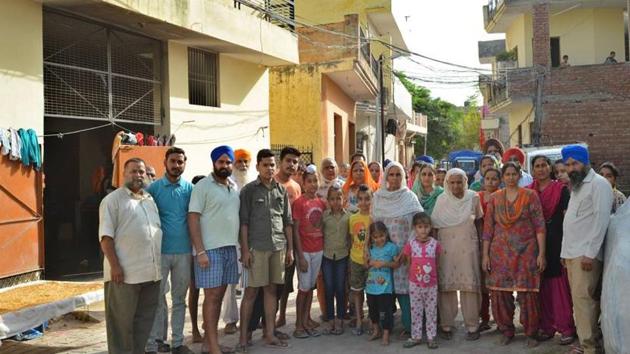 Residents of Pabhat village outside their houses on Saturday. The Zirakpur MC has issued them a notice to vacate their houses, after which a demolition drive will be held on Monday. (HT Photo) Residents of Pabhat village outside their houses on Saturday. The Zirakpur MC has issued them a notice to vacate their houses, after which a demolition drive will be held on Monday. (HT Photo)