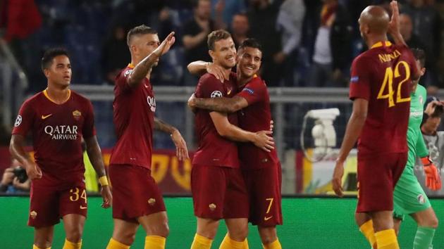 Roma's Edin Dzeko celebrates scoring their second goal with Lorenzo Pellegrini and team mates.(REUTERS)