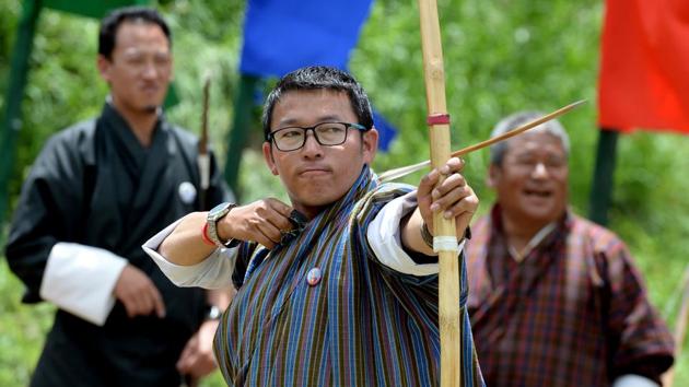 Karma Tshering (C) said Bhutanese archers were not aspiring to global acclaim. “Anybody can shoot with the sophisticated modern bows with the help of release aids and all,” Tshering said. “It’s the traditional archery which is more challenging, you have to focus on both your body and mind,” he said, at a game at Thimpu’s national sports stadium. (Arun Sankar / AFP) 