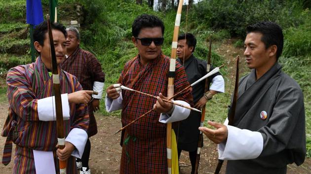 Some say the Bhutanese lack the fiercely competitive streak needed to do well in the sport. The likes of Ygyen Dorji (C) beg to differ. “The rivalry is quite intense. Opponents often plant women in the stands to distract the rivals,” said Dorji, a mental health counsellor and archery enthusiast. “The ladies mimic you, try to pull you down and one has to concentrate hard as pride and honour are at stake.” (Arun Sankar / AFP) 