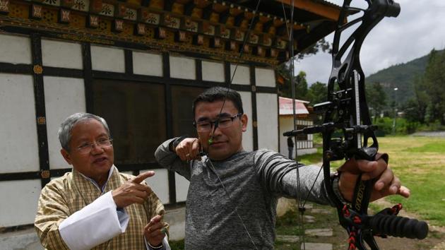 “TV made modern sports available, sports like football and volleyball which are cheaper to play. Suddenly there was competition for our traditional sports,” said Kinzang Dorji (L), president of the BIGSA. “Children had a wider choice unlike the generations before them,” he told AFP. (Arun Sankar / AFP) 