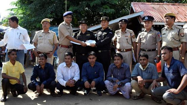 The seven Rohingya men to be deported sit as Indian and Myanmar security officials exchange documents before their deportation on India-Myanmar border at Moreh in the northeastern state of Manipur. The first ever such deportation of Rohingya has spread panic among an estimated 40,000 refugees who have fled to India from its neighbour. (Stringer / REUTERS) The seven Rohingya men to be deported sit as Indian and Myanmar security officials exchange documents before their deportation on India-Myanmar border at Moreh in the northeastern state of Manipur. The first ever such deportation of Rohingya has spread panic among an estimated 40,000 refugees who have fled to India from its neighbour. (Stringer / REUTERS)