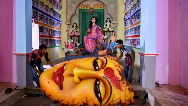 Artists give final touches to a Durga Puja pandal themed on 'violence against women' ahead of Durga puja festival in Kolkata. (Swapan Mahapatra / PTI) Artists give final touches to a Durga Puja pandal themed on 'violence against women' ahead of Durga puja festival in Kolkata. (Swapan Mahapatra / PTI)