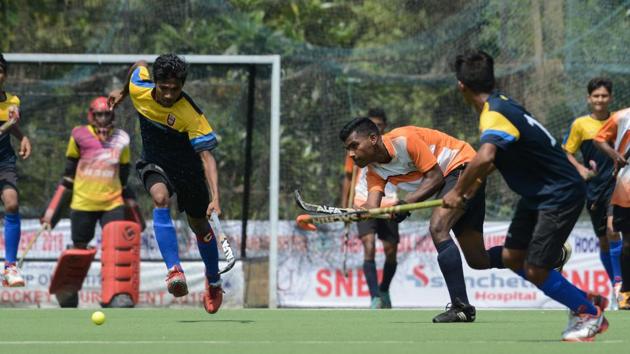 Hockey match played between SNBP academy Pune(in orange and white)and Krida Prabhobini Pune(in blue and yellow) at balewadi stadium, Pune on October 6. (Milind Saurkar/HT Photo)