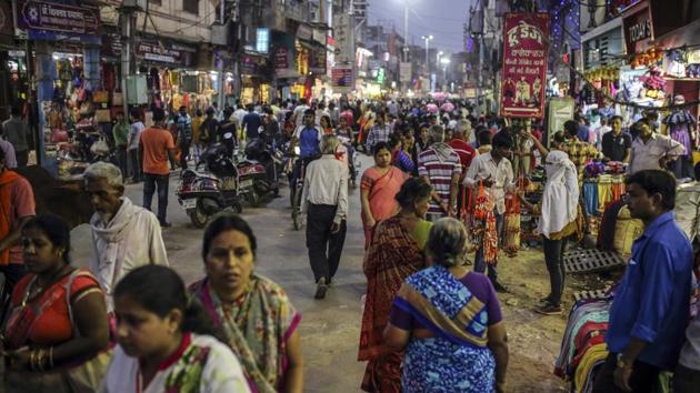 Pedestrians and shoppers walk past stores on a street in Varanasi, Uttar Pradesh. Advance estimates for 2014-15 released in February projected India’s GDP during the year to grow at 7.4%, making it the world’s fastest growing economy surpassing China.(Bloomberg)
