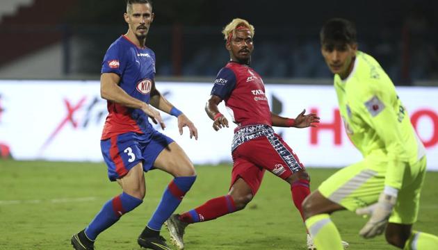 Gourav Mukhi (center) of Jamshedpur FC in action against Bengaluru FC. (AP) Gourav Mukhi (center) of Jamshedpur FC in action against Bengaluru FC. (AP)