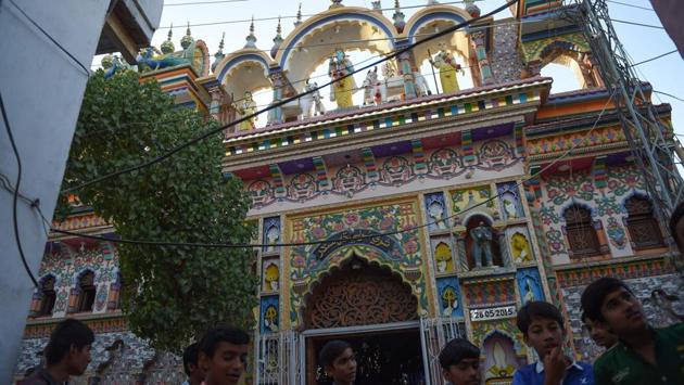 As they enter Shri Krishna temple, the Hindu faithful ring a bell, the sound minglng with the azan, sounded just a few streets away. A relaxed group of young Hindus talk outside the colourful, intricately carved exterior, where not a single guard is employed, in sharp contrast to the Hindu neighbourhoods in the megacity of Karachi, some 300 kilometres away, which are under armed surveillance. (Rizwan tabassum / AFP)