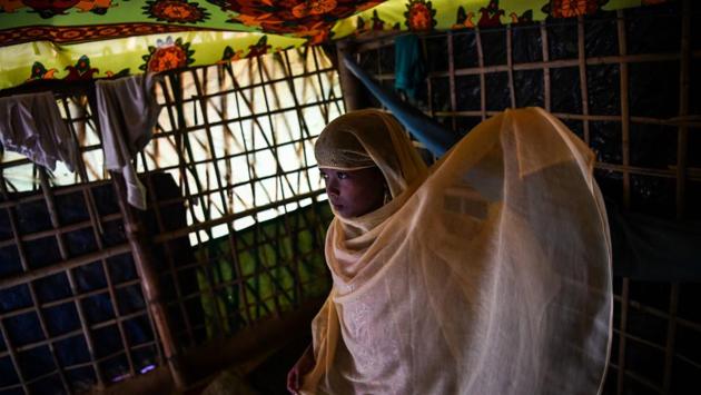 Inside a stifling bamboo shanty, eight-year-old Saleema Khanam throws a bright yellow shawl over her head and steps out into an enormous refugee camp in Bangladesh, clutching her treasured Quran. She is the only girl in her local madrassa or Islamic seminary, catering to Rohingya children driven from Buddhist-majority Myanmar by a wave of genocidal violence. (Chandan Khanna / AFP) Inside a stifling bamboo shanty, eight-year-old Saleema Khanam throws a bright yellow shawl over her head and steps out into an enormous refugee camp in Bangladesh, clutching her treasured Quran. She is the only girl in her local madrassa or Islamic seminary, catering to Rohingya children driven from Buddhist-majority Myanmar by a wave of genocidal violence. (Chandan Khanna / AFP)
