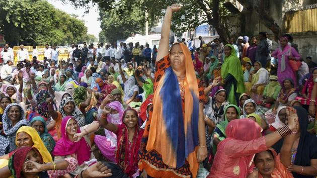 EDMC sanitation workers during their protest 'dharna' EDMC headquarters at Patparganj in east Delhi on October 9. (AP Photo) EDMC sanitation workers during their protest 'dharna' EDMC headquarters at Patparganj in east Delhi on October 9. (AP Photo)