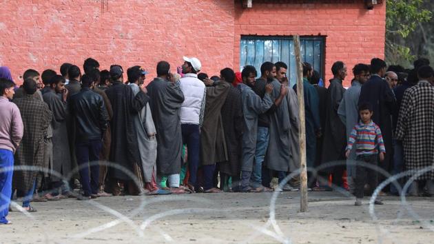 People stand in queue to cast their vote in Inderkoot, Bandipora district, Jammu and Kashmir. Amid shutdown called by separatists in poll-bound areas, more than 380 local bodies spread across 13 districts entered the second phase of the urban local bodies’ elections in Jammu and Kashmir. The elections, to be held in four phases, began on October 8 and will end on October 16. (Waseem Andrabi / HT Photo)