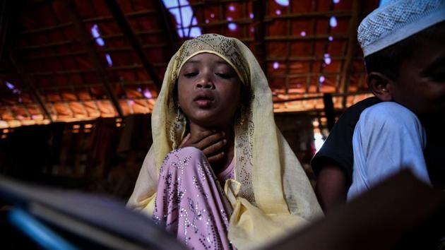 Saleema studies inside a makeshift madrassa in Kutupalong camp. The madrassa is just a short distance from her family’s shack to the school, one of thousands to spring up in the world’s largest refugee camp since the influx of Rohingya Muslims last year. (Chandan Khanna / AFP) Saleema studies inside a makeshift madrassa in Kutupalong camp. The madrassa is just a short distance from her family’s shack to the school, one of thousands to spring up in the world’s largest refugee camp since the influx of Rohingya Muslims last year. (Chandan Khanna / AFP)