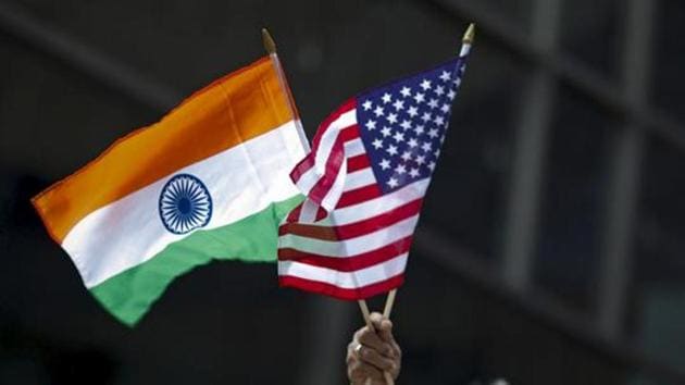 A man holds the flags of India and the US flag in New York.(REUTERS)
