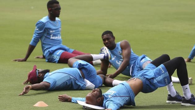 West Indies' cricket player Roston Chase, front, along with teammates perform stretch exercises during a practice session ahead of their second test match against India in Hyderabad(AP) West Indies' cricket player Roston Chase, front, along with teammates perform stretch exercises during a practice session ahead of their second test match against India in Hyderabad(AP)