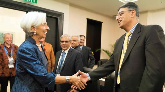 IMF Managing Director Christine Lagarde (L) greeting Pakistan Finance Minister Asad Umar (R) at the Bali Convention Centre during the 2018 IMF/World Bank annual meetings in Nusa Dua on the Indonesian resort island of Bali.(AFP Photo/IMF/Stephen Jaffe)