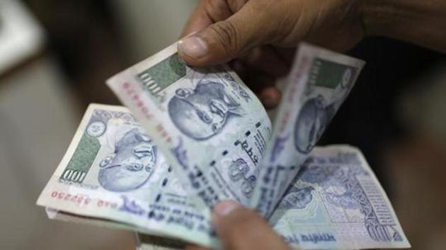 An employee counts Indian rupee currency notes inside a private money exchange office in New Delhi July 5, 2013. India's central bank was seen selling dollars via state-run banks on Friday as the rupee approached its record low of 60.76 seen on June 26, four dealers said.(Reuters File Photo)