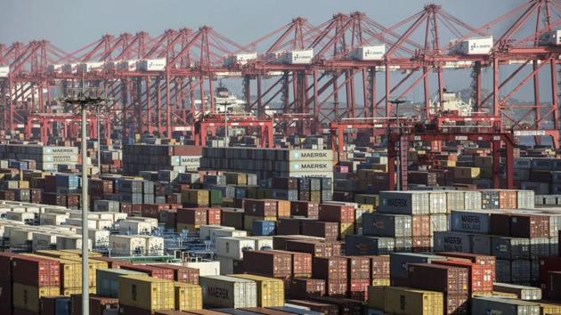 Containers sit stacked next to gantry cranes at the Yangshan Deep Water Port in Shanghai.(Bloomberg)