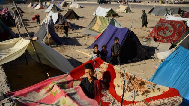 Children look on from their tents. Beaten by the inhospitable conditions, many families in rural areas decided to travel hundreds of kilometres in the back of rented trucks through districts contested by Taliban fighters and government forces to reach the city of Herat. There, they set up pitiful, makeshift tents on the rocky outskirts of the provincial capital. (Hoshang Hashimi / AFP) Children look on from their tents. Beaten by the inhospitable conditions, many families in rural areas decided to travel hundreds of kilometres in the back of rented trucks through districts contested by Taliban fighters and government forces to reach the city of Herat. There, they set up pitiful, makeshift tents on the rocky outskirts of the provincial capital. (Hoshang Hashimi / AFP)