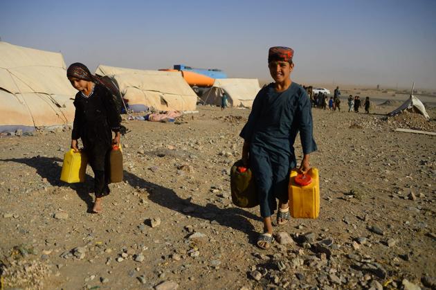 Children carry water filled from a tanker at a camp. The drought, affecting 2.2 million people across Afghanistan, was triggered by a huge shortfall in snow and rain last winter and has roughly 1.4 million people in urgent need of food assistance --the majority in the western region, United Nations Office for the Coordination of Humanitarian Affairs (OCHA) reports. (Hoshang Hashimi / AFP) Children carry water filled from a tanker at a camp. The drought, affecting 2.2 million people across Afghanistan, was triggered by a huge shortfall in snow and rain last winter and has roughly 1.4 million people in urgent need of food assistance --the majority in the western region, United Nations Office for the Coordination of Humanitarian Affairs (OCHA) reports. (Hoshang Hashimi / AFP)