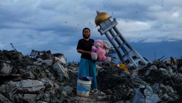 A woman holds a stuffed rabbit toy after it was found at her destroyed home where she said she had lost her three children, in Palu, Central Sulawesi, Indonesia. (Jorge Silva / REUTERS)