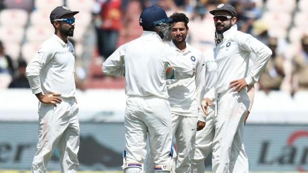 Indian cricketer Kuldeep Yadav (C) celebrates with captain Virat Kohli (R) after the dismissal of West Indies cricketer Shimron Hetmyer during the first day's play of the second Test cricket match between India and West Indies at the Rajiv Gandhi International Cricket Stadium.(AFP)